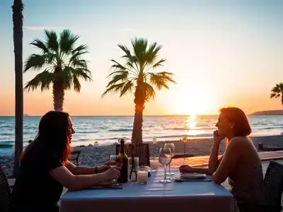 Couple dining at sunset on a beach in Paphos.