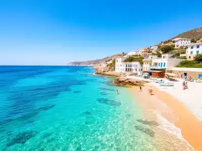 Beautiful Greek beach with turquoise waters and white buildings.