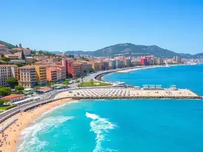 Coastal view of Nice with beach and colorful buildings.