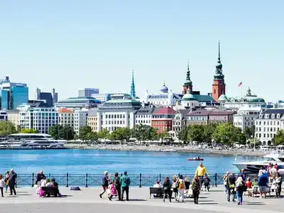 Helsinki waterfront with couples, families, and elderly visitors.