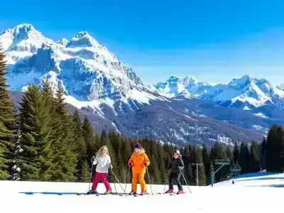 Family skiing together in a snowy mountain landscape.
