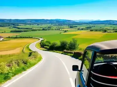 Car driving on a scenic road in French countryside.