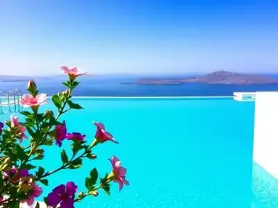Infinity pool with view of Santorini&rsquo;s blue skies.