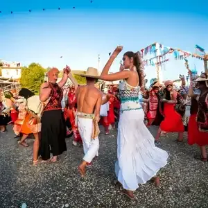 Couples dancing at a vibrant local festival in Rhodes.