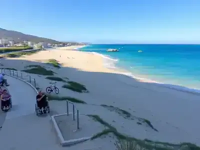 Accessible beach in Greece with people enjoying the sun.