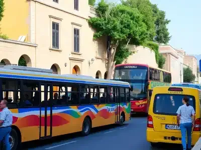Colorful buses and taxis on a lively Greek street.