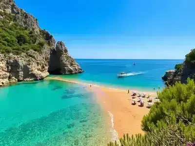 Scenic Liguria beach with turquoise water and rocky cliffs.