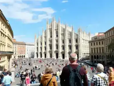 Milan&rsquo;s Duomo Cathedral with bustling street activity.