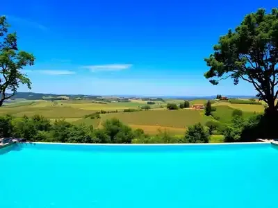 Infinity pool with scenic Tuscan countryside view.