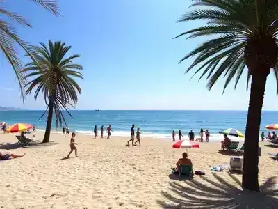 Families enjoying a sunny beach day at a coastal resort.