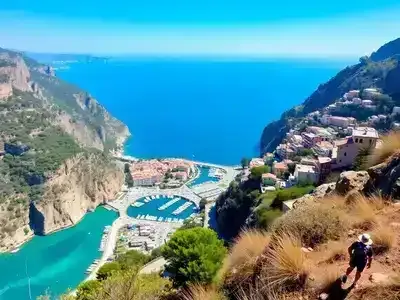 Hikers on a cliff with coastal village in background.