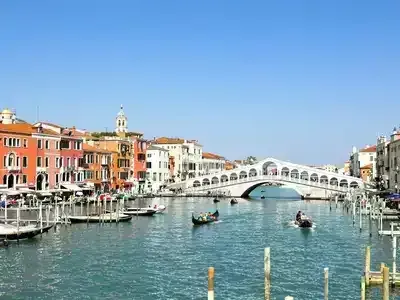 Venice canals with gondolas and historic buildings.