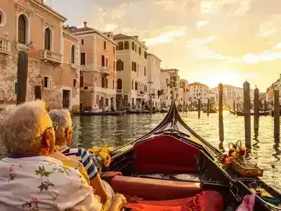 Elderly couples enjoying a gondola ride in Venice.