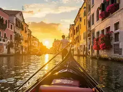 Gondola ride in Venice during a picturesque sunset.