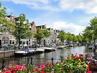 Amsterdam canals with houseboats and bicycles in spring.