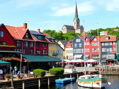Colorful waterfront of Stavanger with historic buildings and tourists.