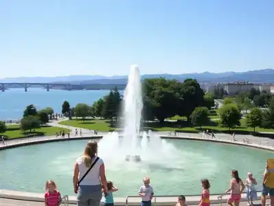 Families enjoying Geneva&rsquo;s Jet d&rsquo;Eau fountain in summer.