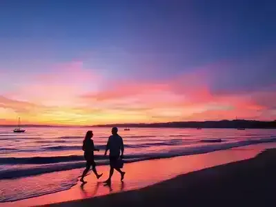 Couples walking on the beach during a sunset in Izmir.